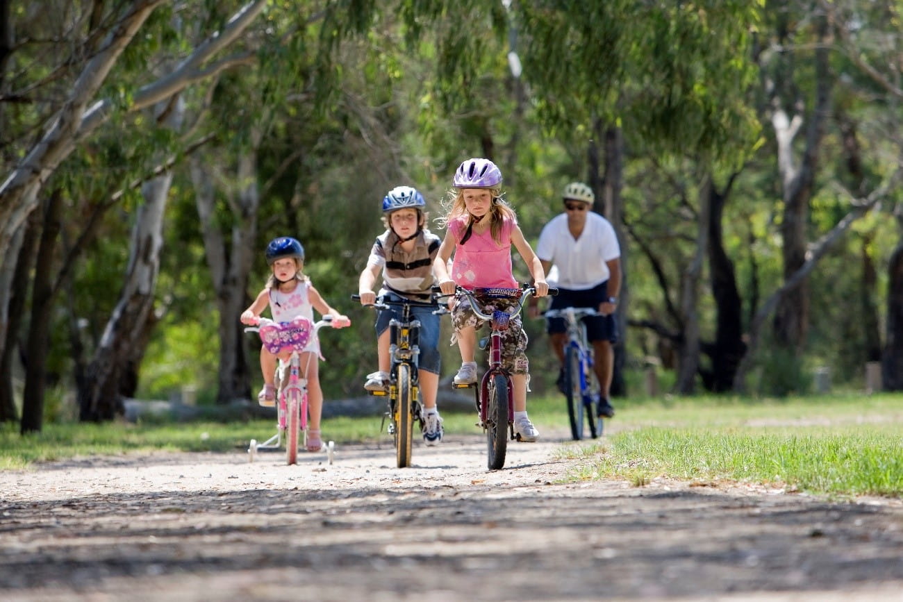 A family riding bikes in a park