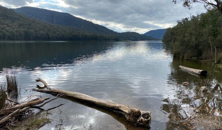 A view of Lake William Hovell with the mountain ranges reflected in the surface.