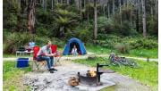 A couple in their later twenties enjoy a joke while at their campsite at Lake Elizabeth Campground in the Great Otway National Park.