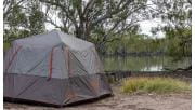 A large square grey tent pitched overlooking the water at Lake Hattah Campground at Hattah-Kulkyne National Park