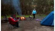 A couple and their dog camp around a fire at Jerusalem Creek camp ground.