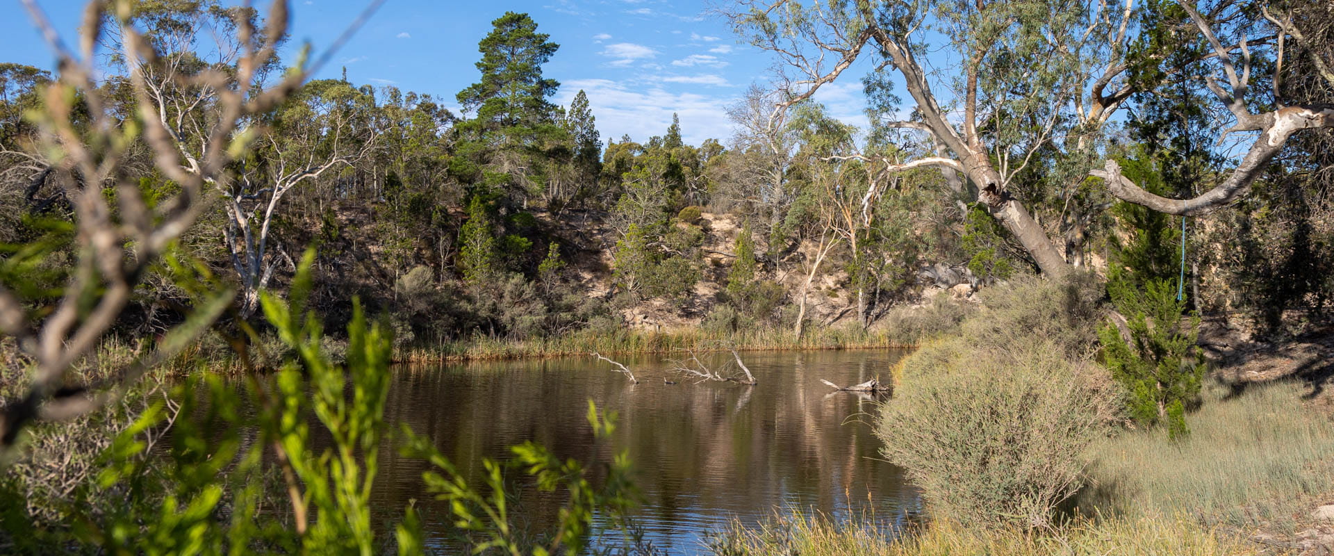 A winding river in a rugged bushland landscape.