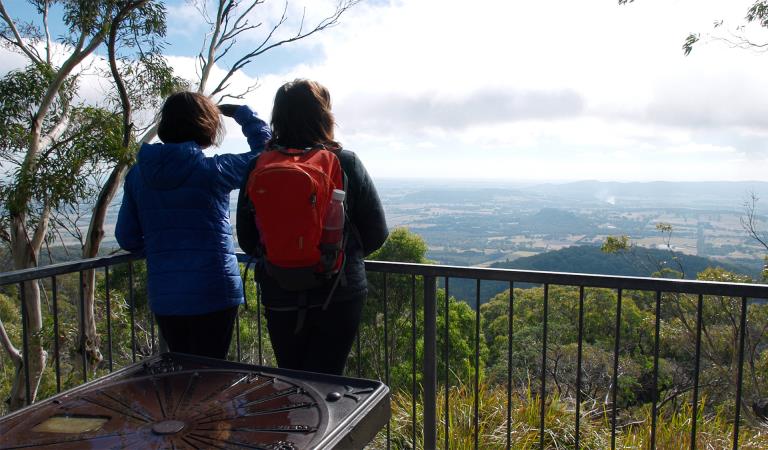 Two women look out at the scenery from Camel's Hump.