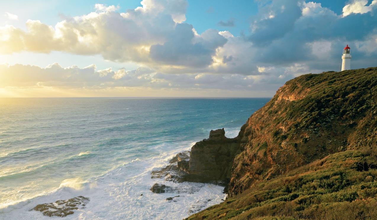 A rocky outcrop with views out into a brilliant blue ocean