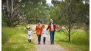 A family walk along a sealed path in Westerfolds Park.