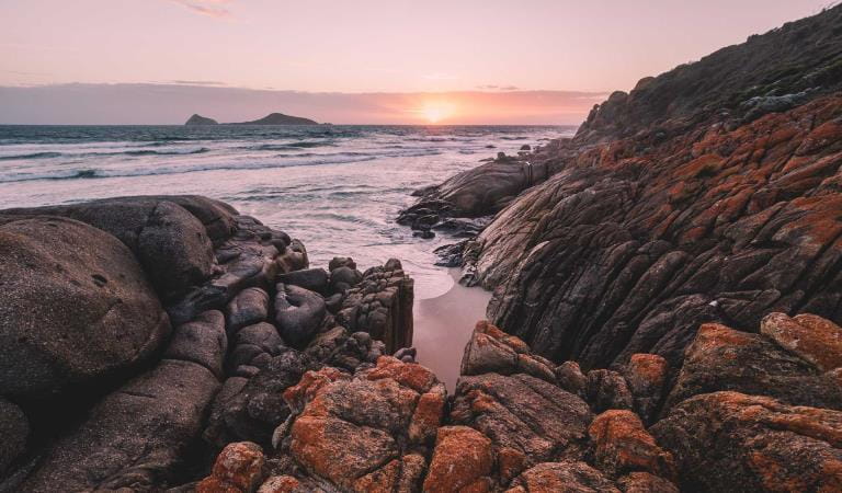 Sunset on the rocks at Whiskey Bay in Wilsons Promontory National Park.