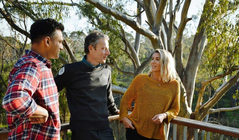 A ranger chats with two park goers in Yarra Bend Park.