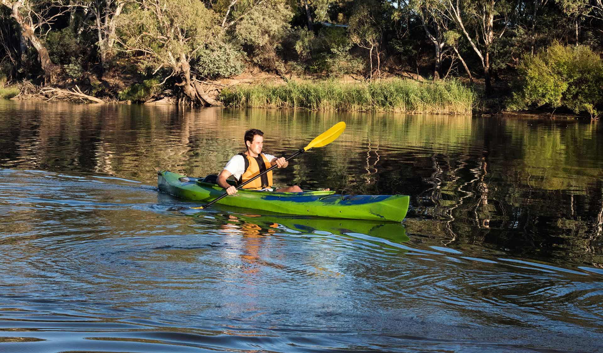 A man kayaks down the river.