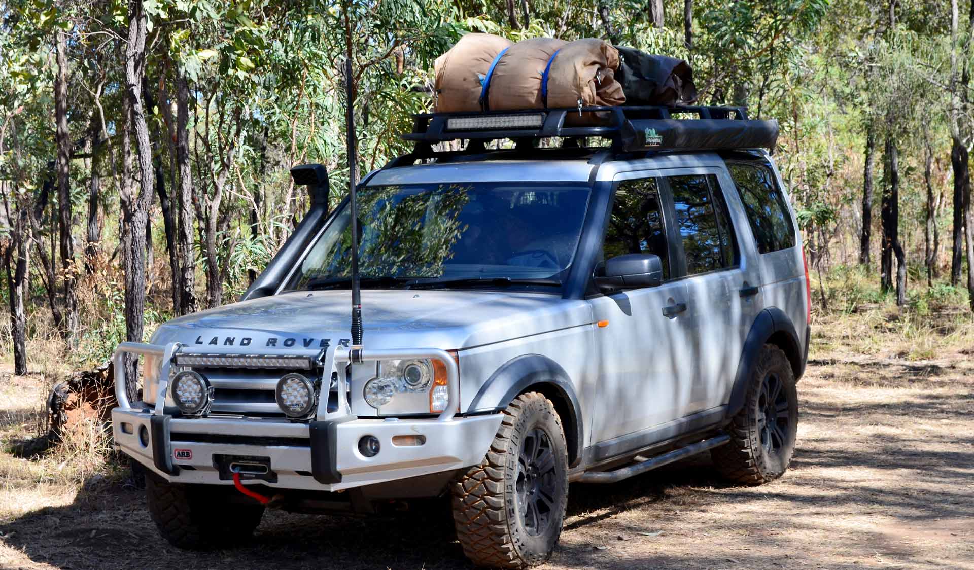 A 4WD with a swag on the roof.