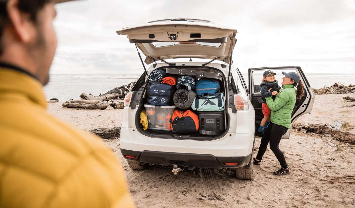 A family with their car full of Macpac gear