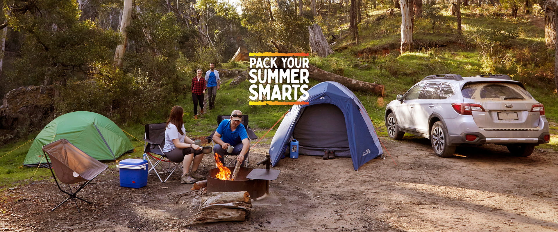 Four friends at a campsite with tents and a car with the text overlay 'pack your summer smarts'.