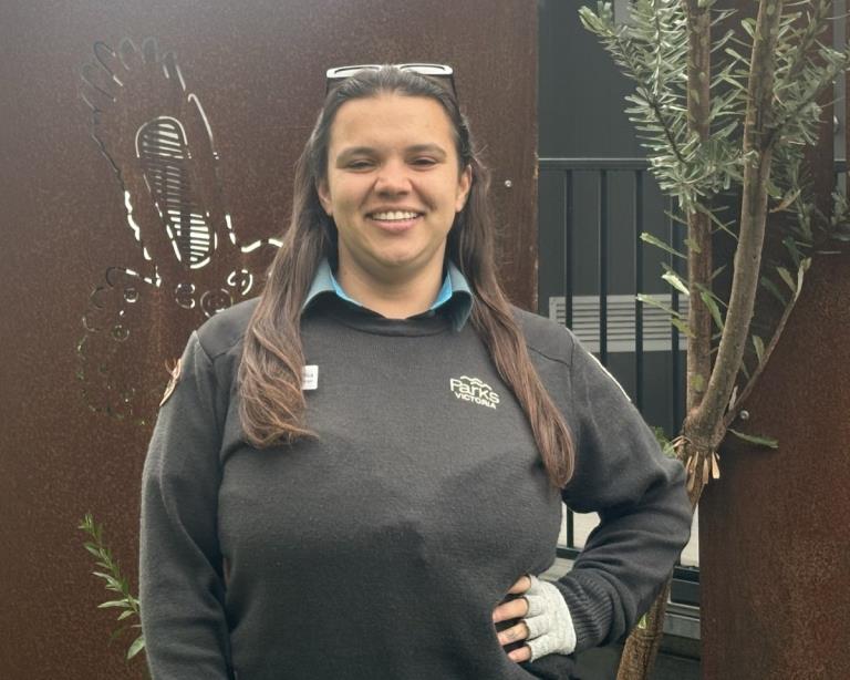 Taungurung Ranger Nartika Taylor smiling to the camera and wearing Parks Victoria uniform