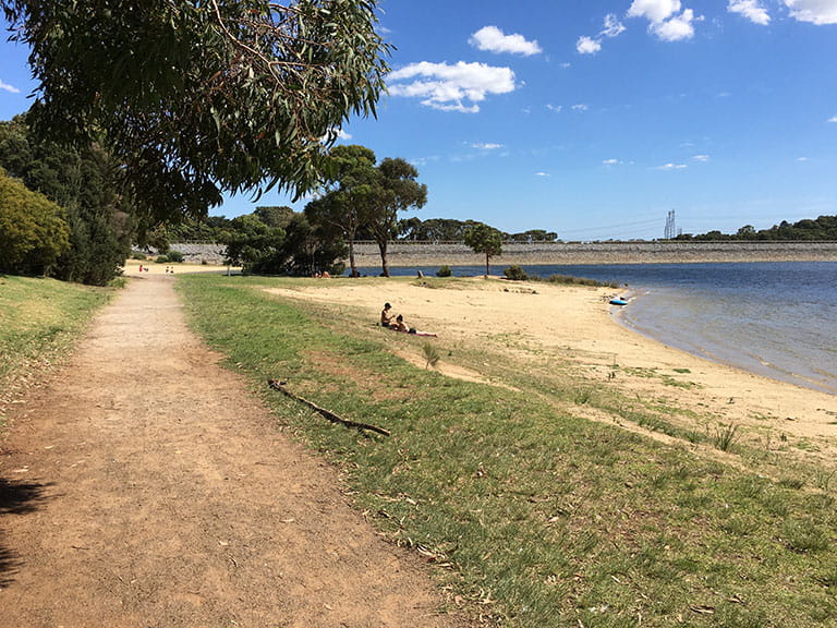 Path alongside lake at Lysterfield Park.