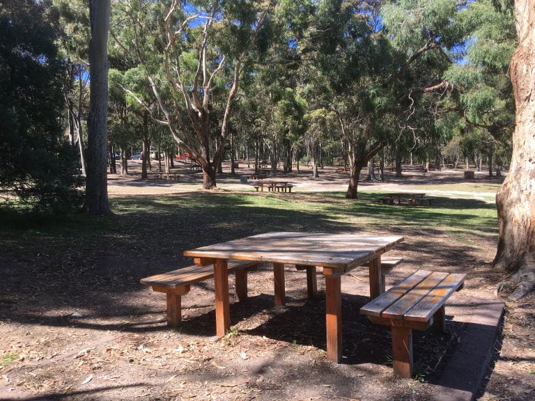 Picnic table and benches at Lysterfield Park.