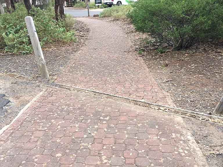 Spoon drain on the paved access path at the carpark in Organ Pipes National Park.