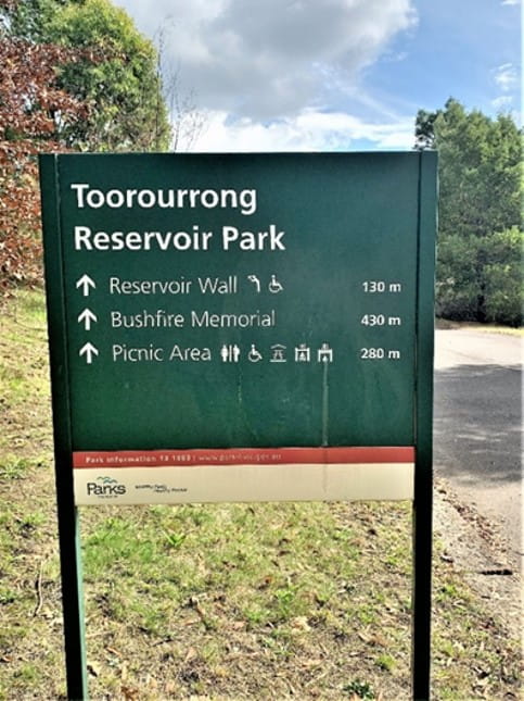 Secondary signage on entry path with accessible icons and distance 