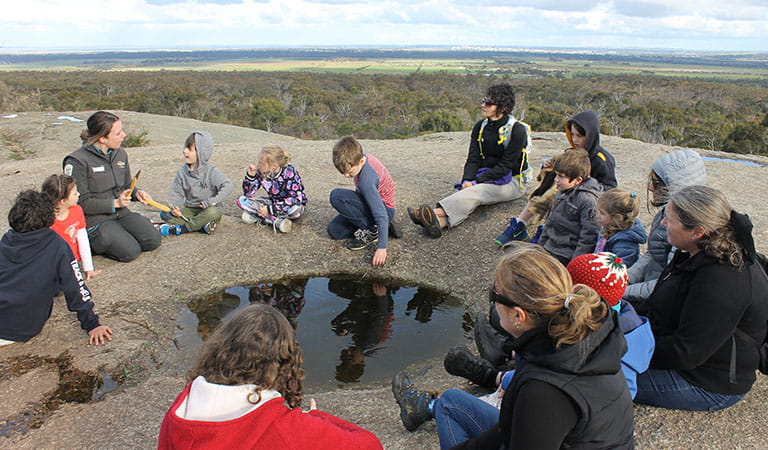 Gathering of kids and adults listening to a ranger at You Yangs Regional Park