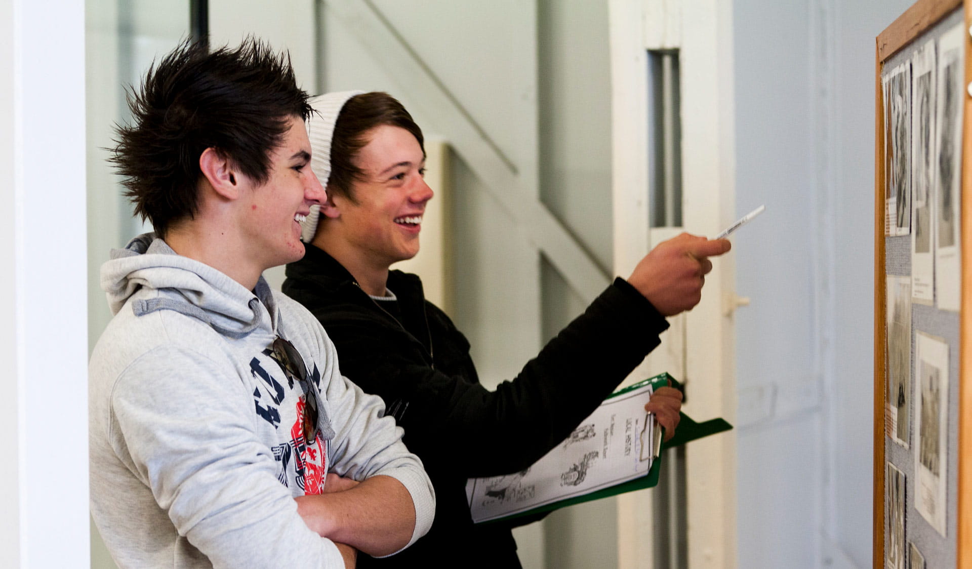 Two male teenagers studying a display