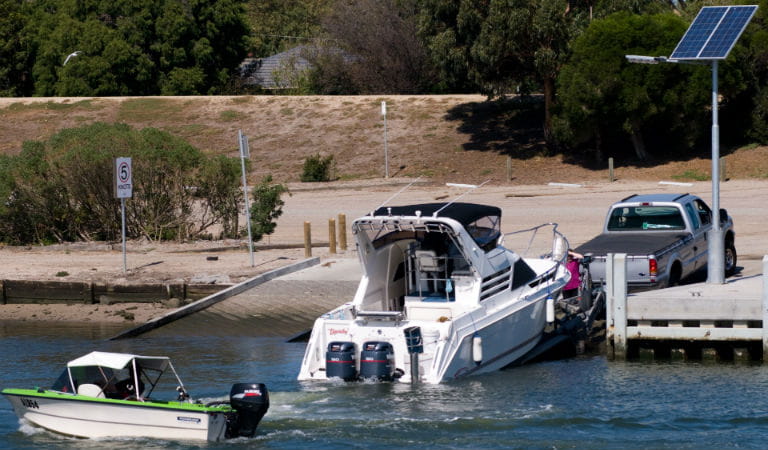Car with boat on boat ramp