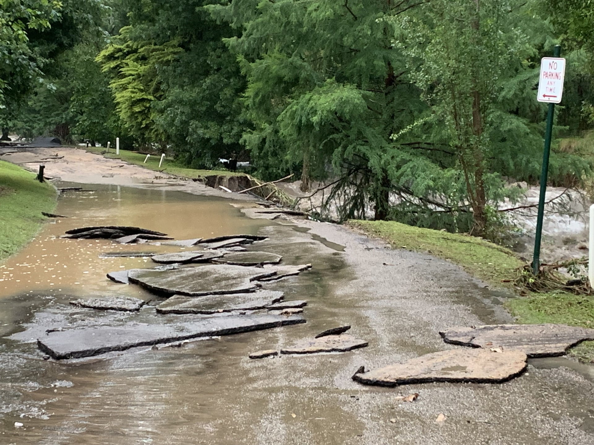 Caves Road into Buchan Caves Reserve with asphalt lifted and moved by flood water