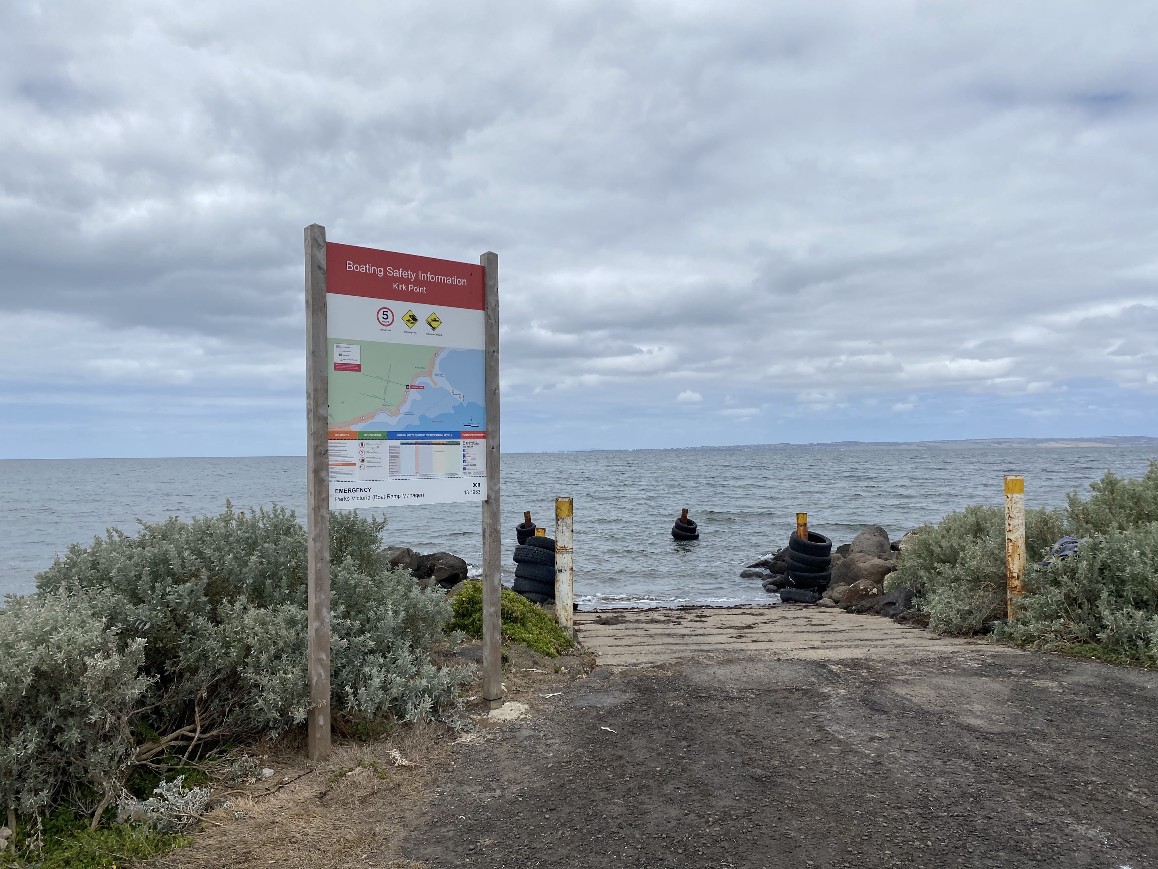 Boatramp to ocean with a warning sign