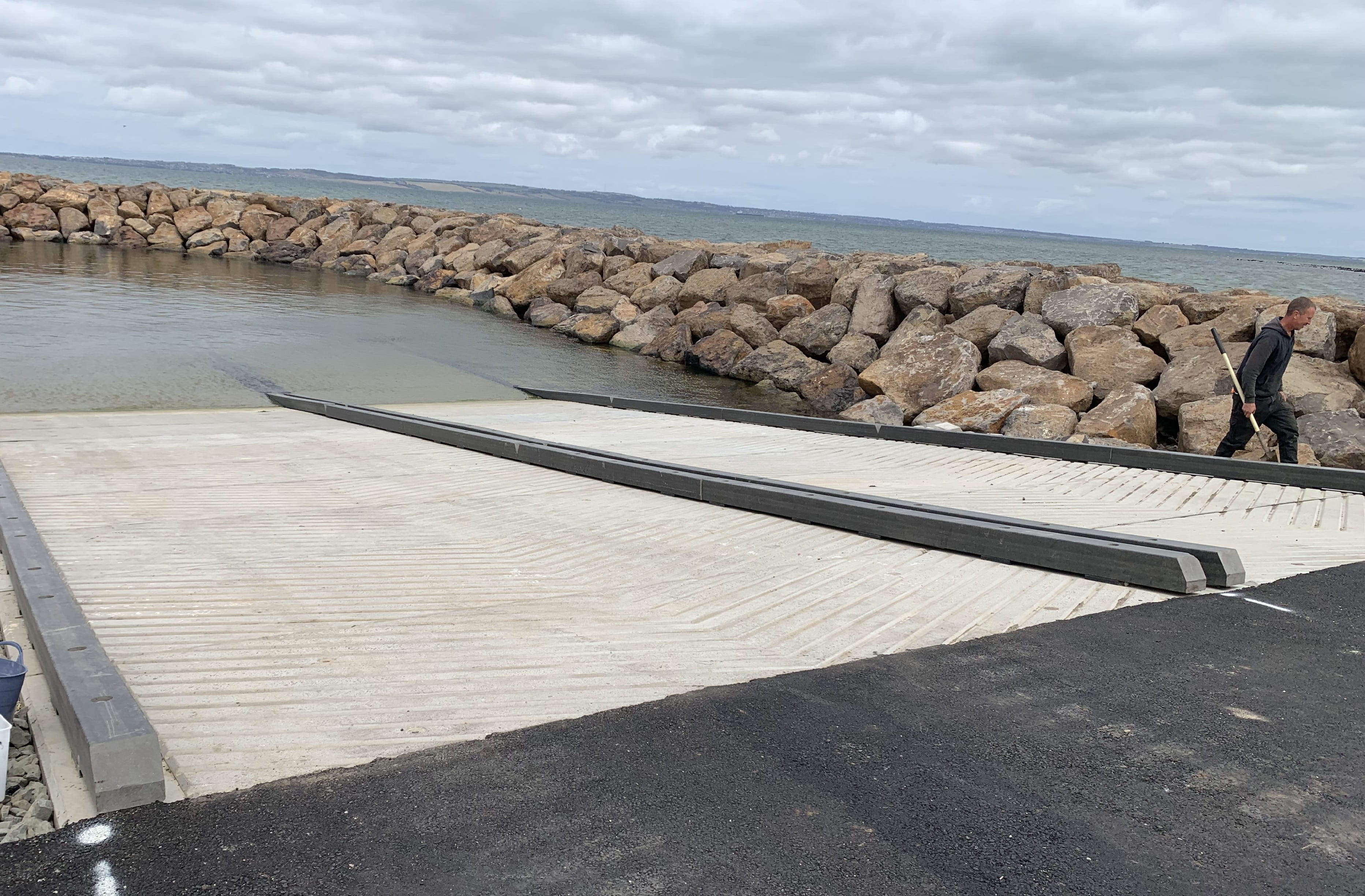 Concrete boat ramp with breakwater in background