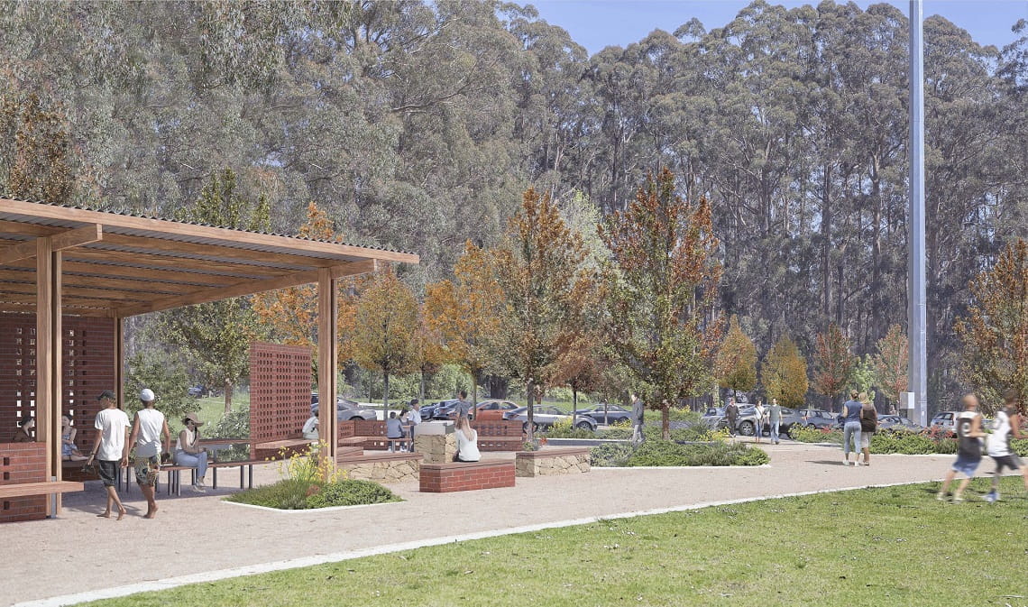 Design render of Olinda Stage 2 project, including a shelter, seating and barbecues overlooking a grassed area, framed by tall trees. 