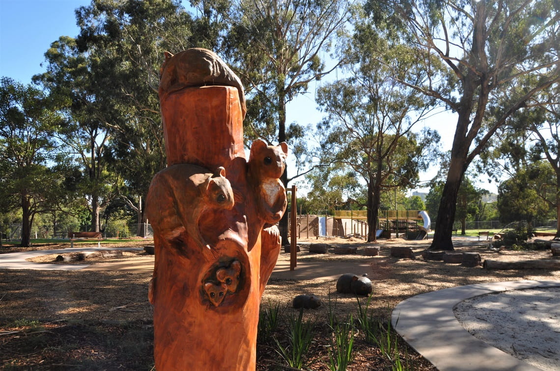 The new playscape includes wooden sculptures of native animals, including a family of possums. 