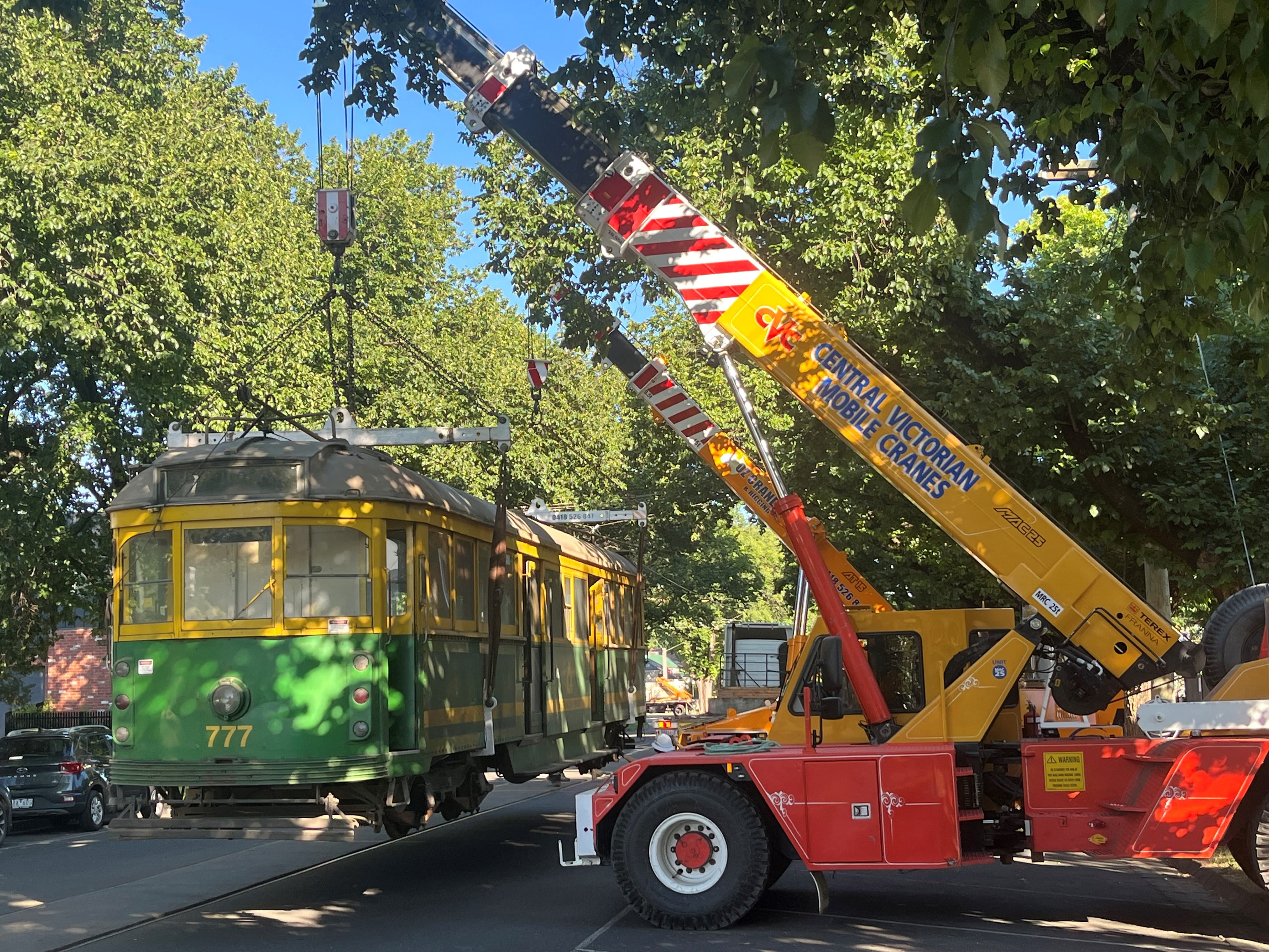 Tram being unloaded by a crane