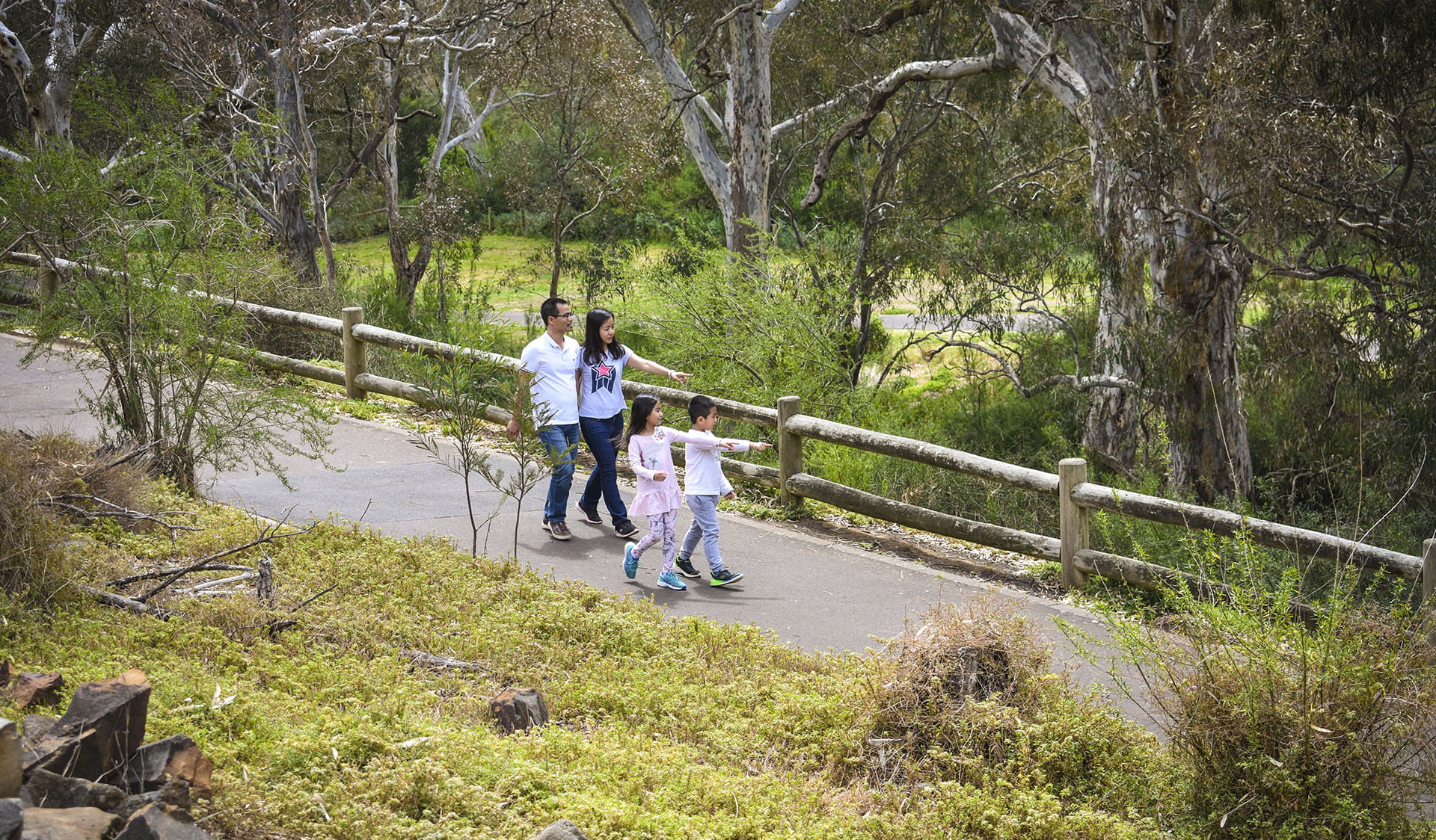 Family walking along a path at Brimbank Park