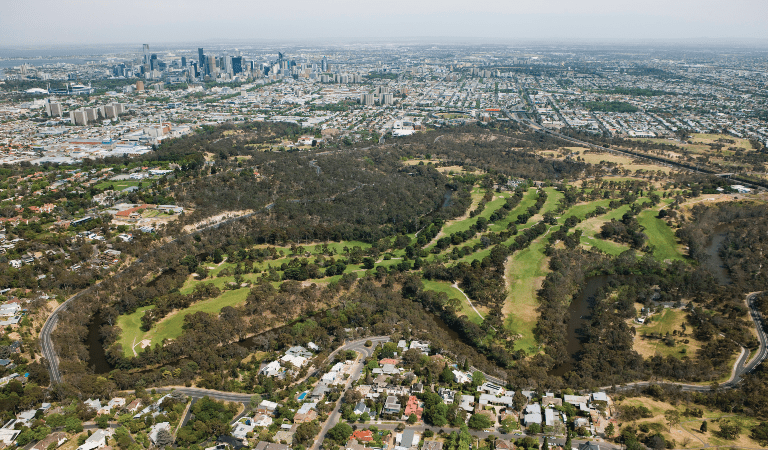 Aerial view of Melbourne CBD and network of parks through suburbs