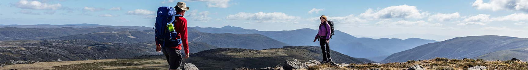 Two hikers reach the summit of Mount Nelse at Bogong High Plains