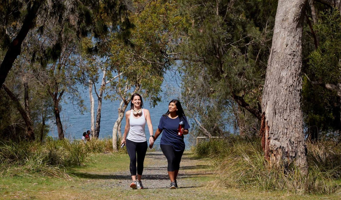 Two friends walking in Lysterfield Park.