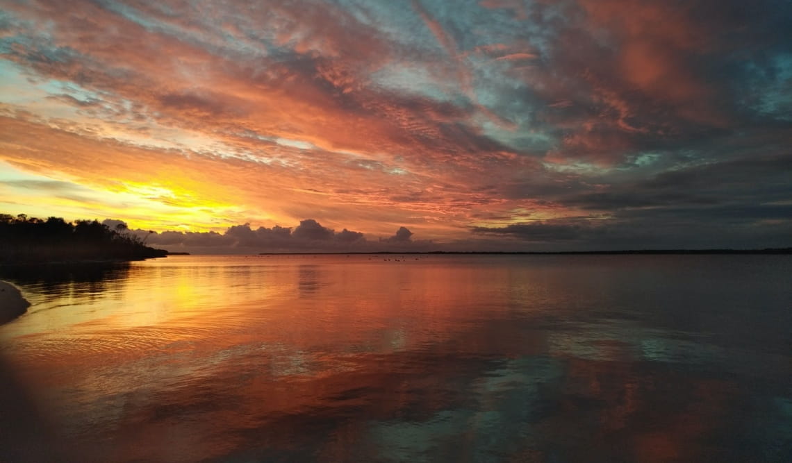 A sunset over a lake in The Lakes National Park. 