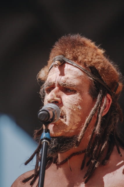 Brett Clarke performing into microphone