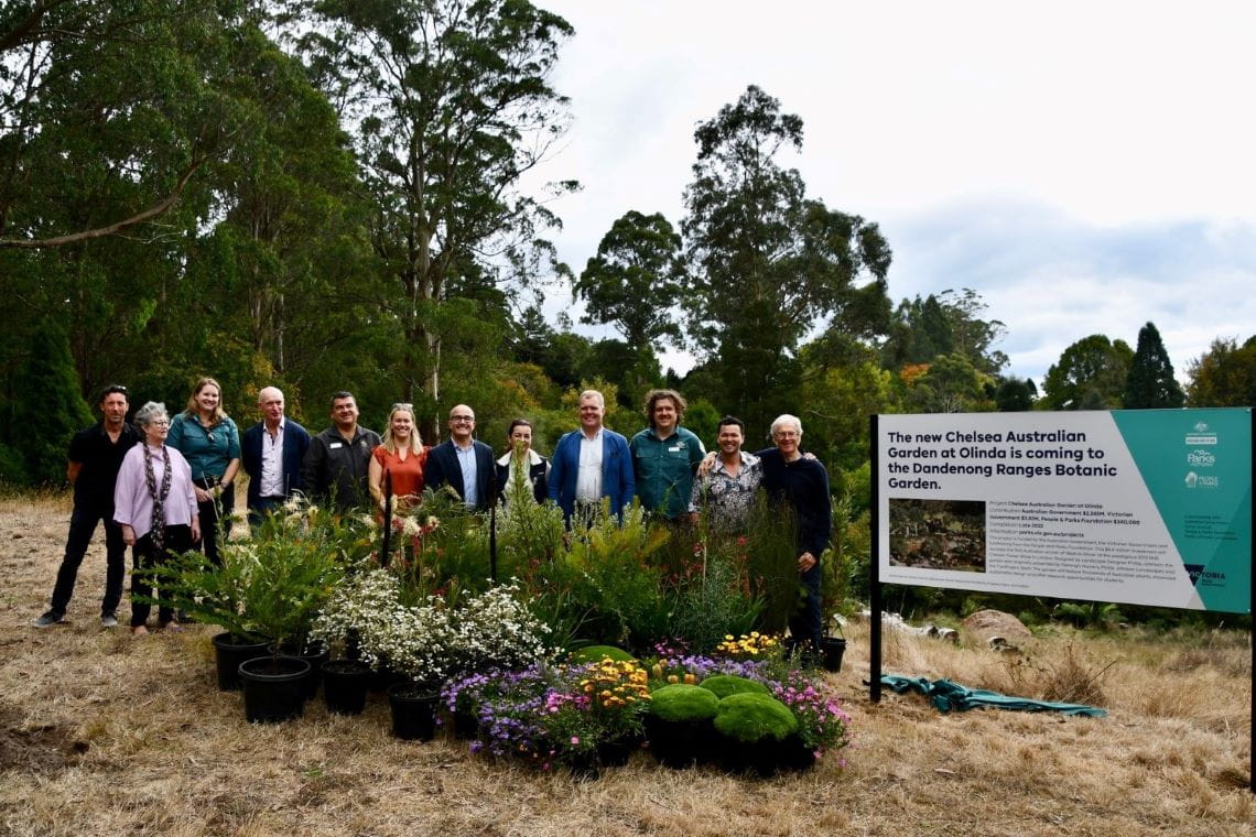 A group of men and women standing next to a sign announcing the Chelsea Australian Garden.