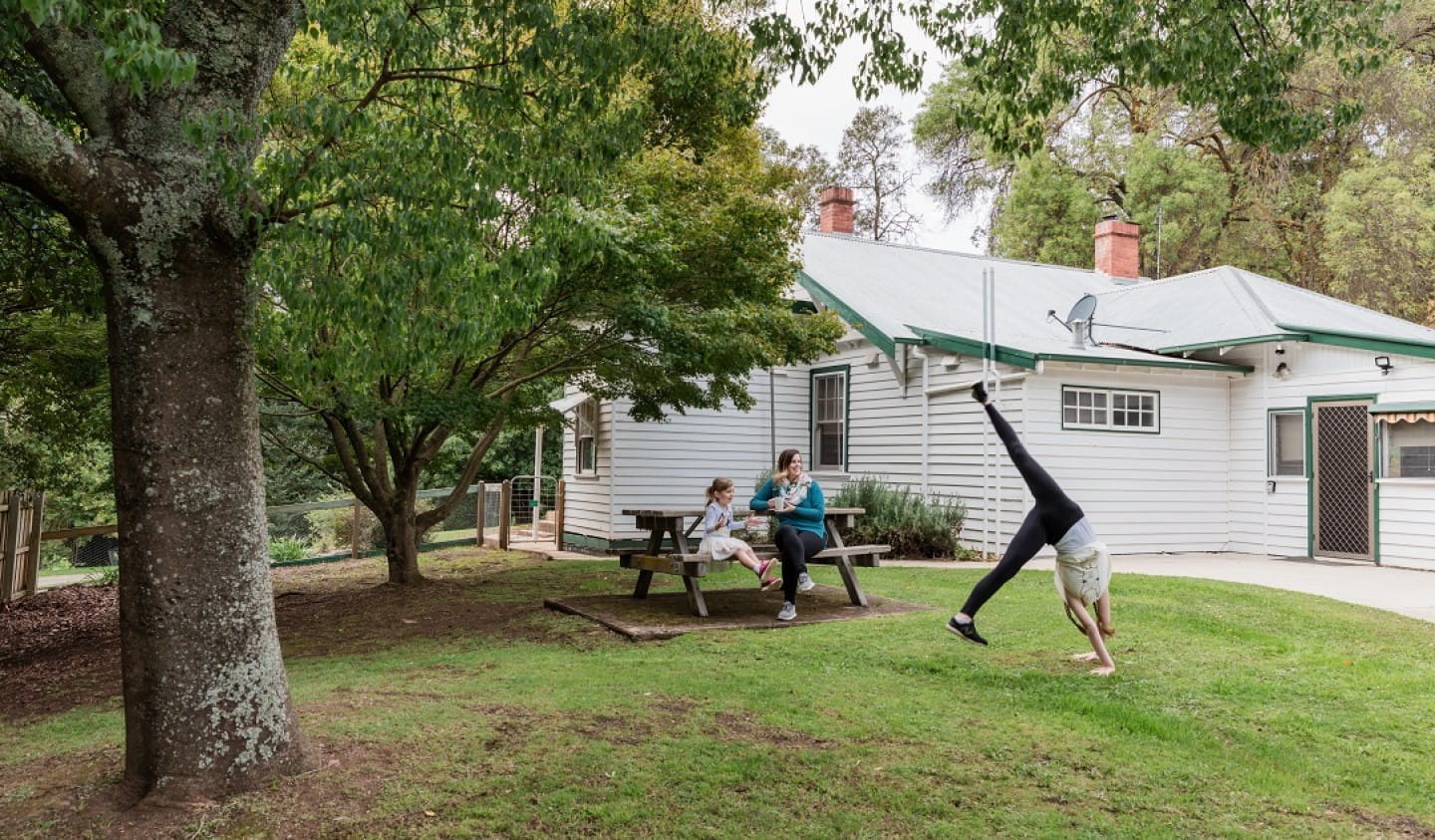 Family in backyard of Caves House