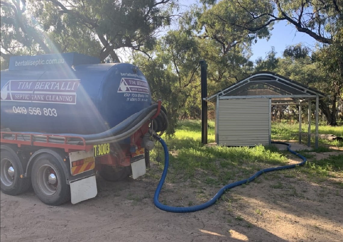 Image shows a truck with a hose connected to the toilet facilities
