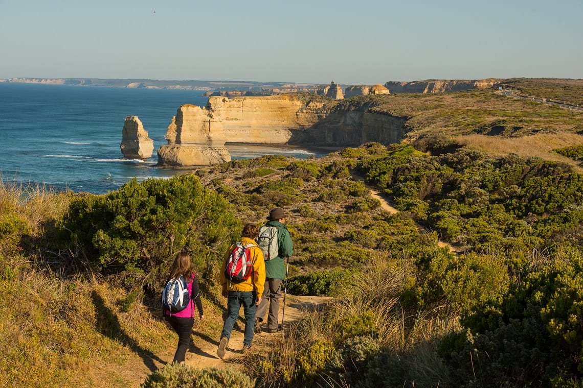 Hikers along the Great Ocean Walk look toward Twelve Apostles