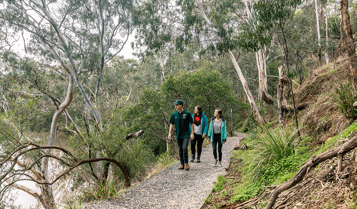 A volunteer guide leads two females on a flying fox tour in Yarra Bend Park