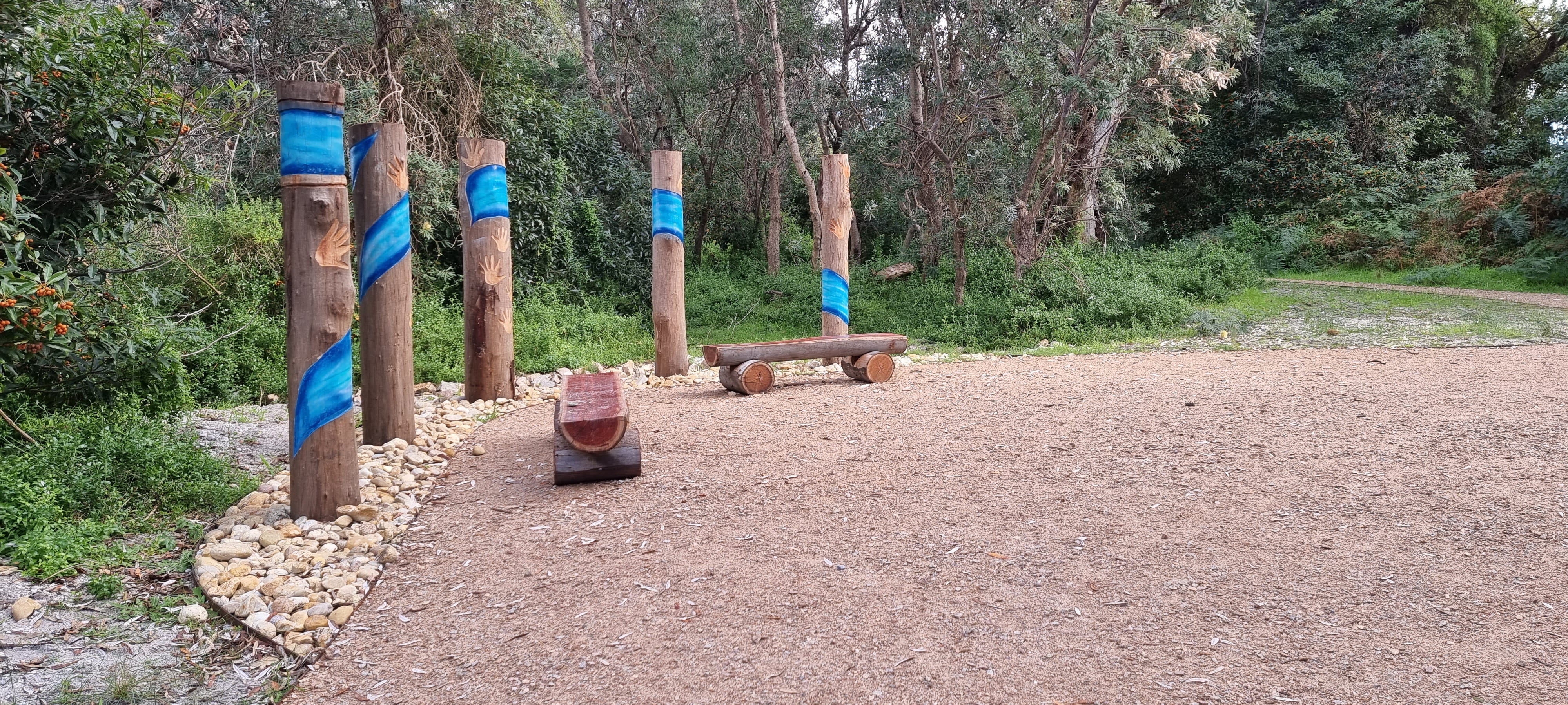 Artwork poles and seating along path