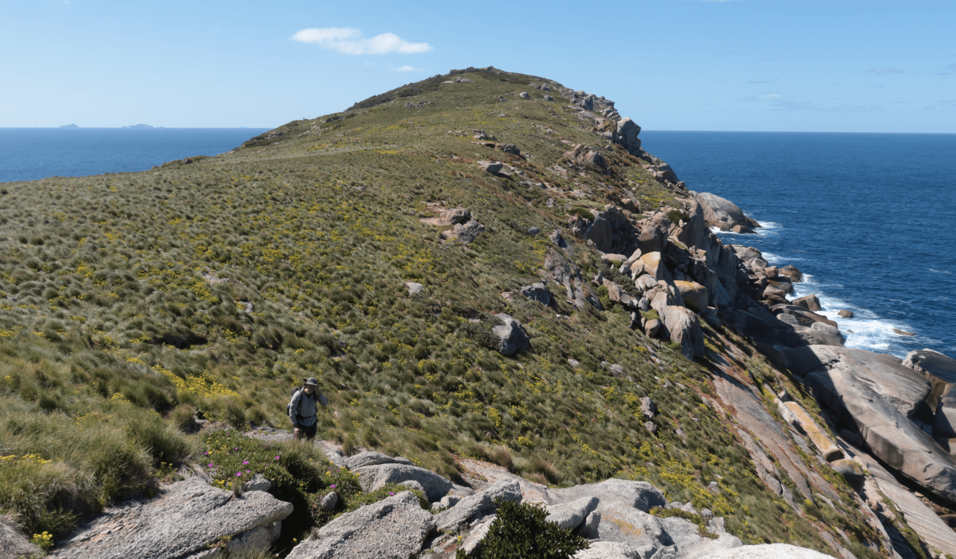 Scenic image of a secluded island, a researcher is in the foreground