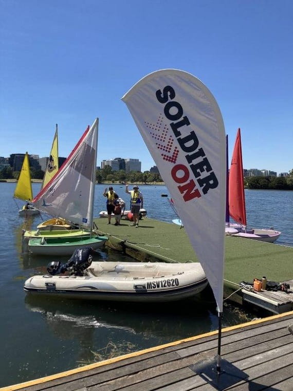 Soldier On banner by the boats at Albert Park Lake, Bunurong Country.