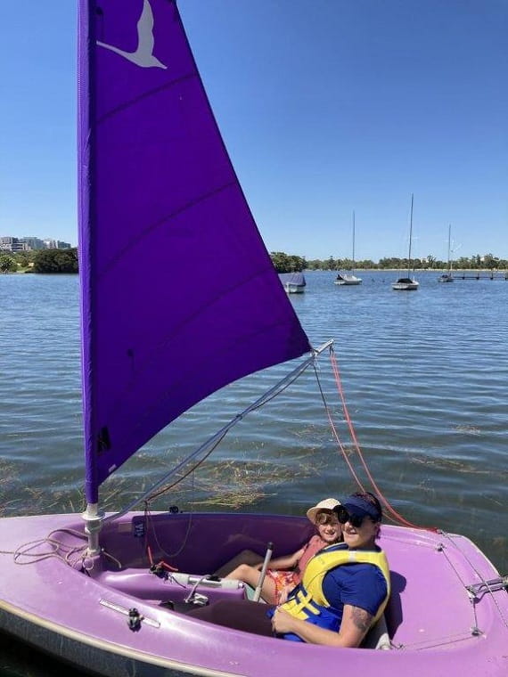 Adult and child participants sailing together on Albert Park Lake, Bunurong Country.