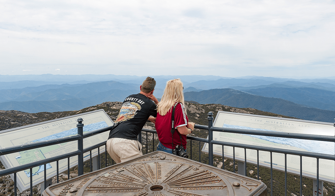 A couple looks out of the mountains from The Horn, Mount Buffalo National Park