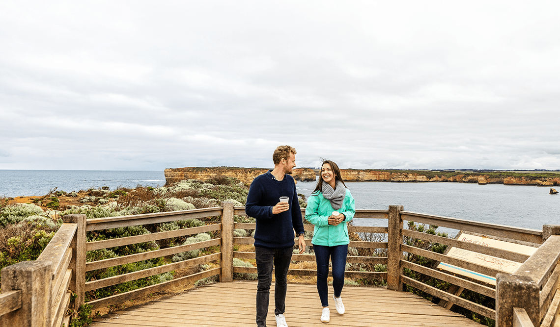 A couple enjoy a coffee at Bay of Islands, Port Campbell National Park