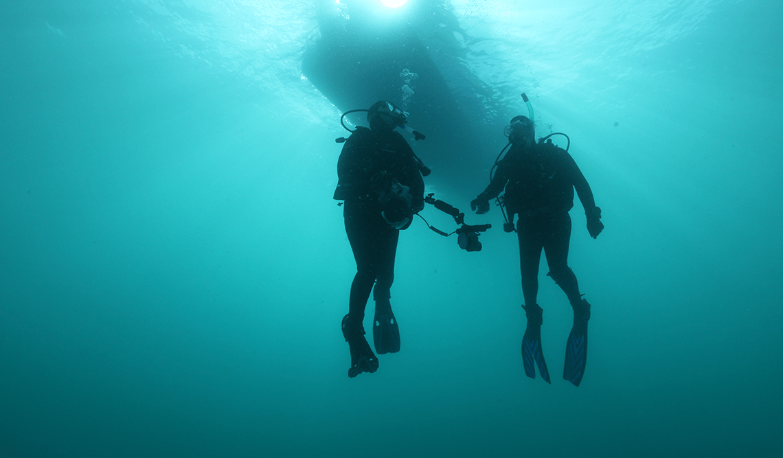 Two scuba divers at The Arches Marine Sanctuary