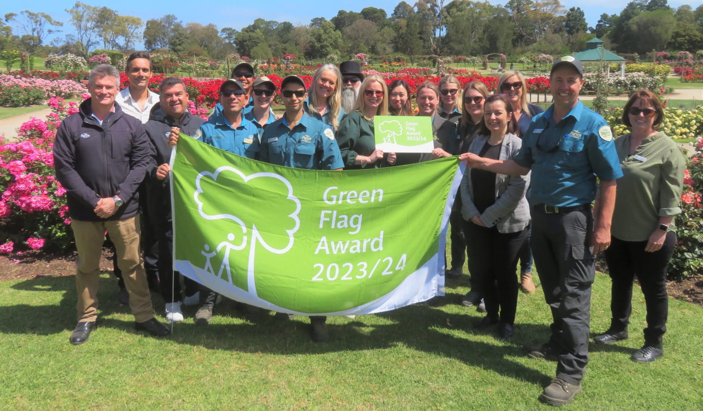 Parks Victoria staff celebrate Werribee Park's Green Flag Award in the Victorian State Rose Garden.