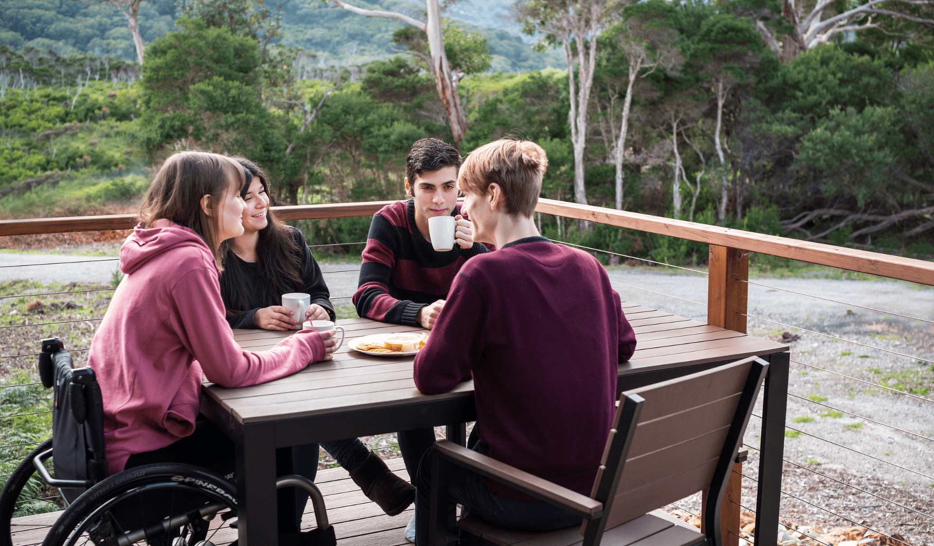 Group of friends sitting at accommodation in Tidal River, Wilsons Promontory National Park