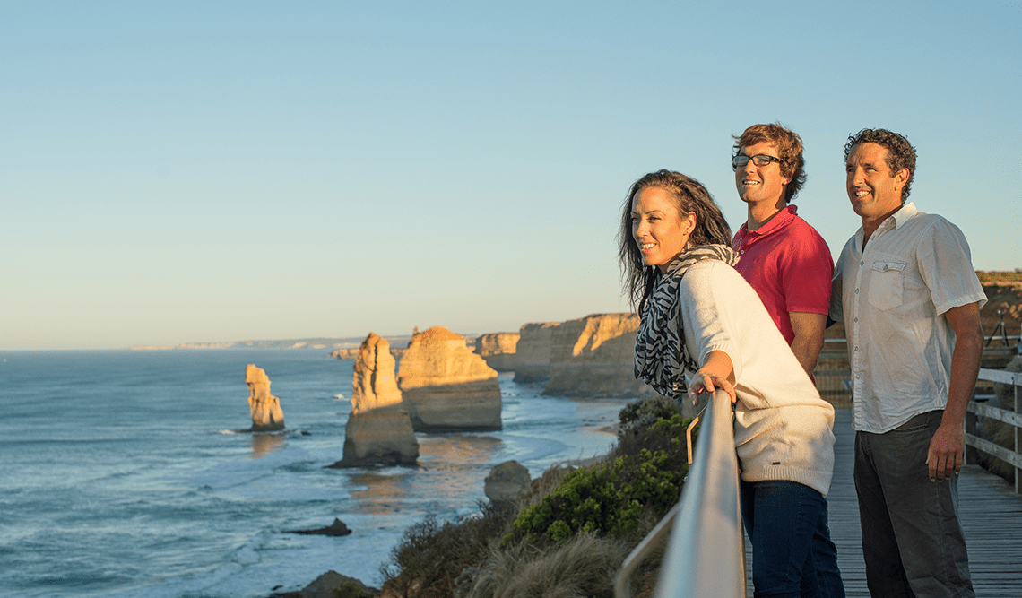Three friends look out across the Twelve Apostles in Port Campbell National Park